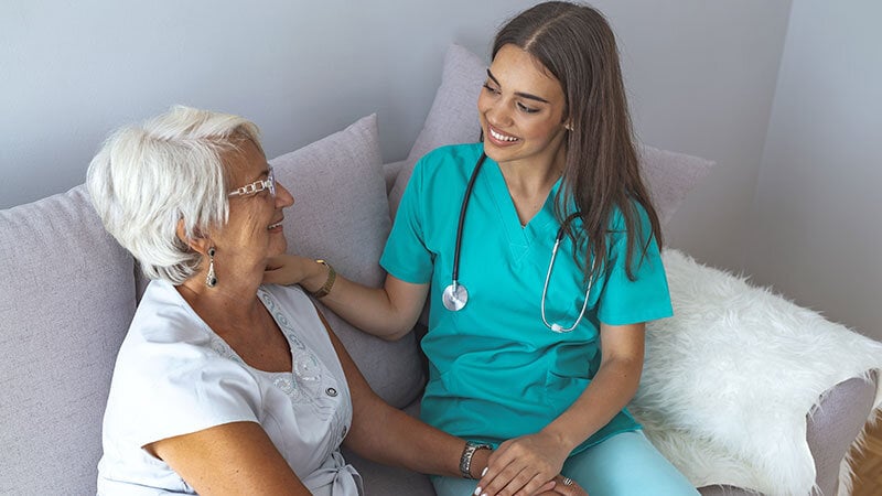 older woman talking with hospice inpatient care nurse