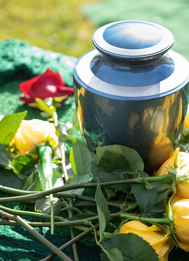 Opal Cremation Services in Los Angeles metal urn surrounded by flowers at cremation memorial service in LA