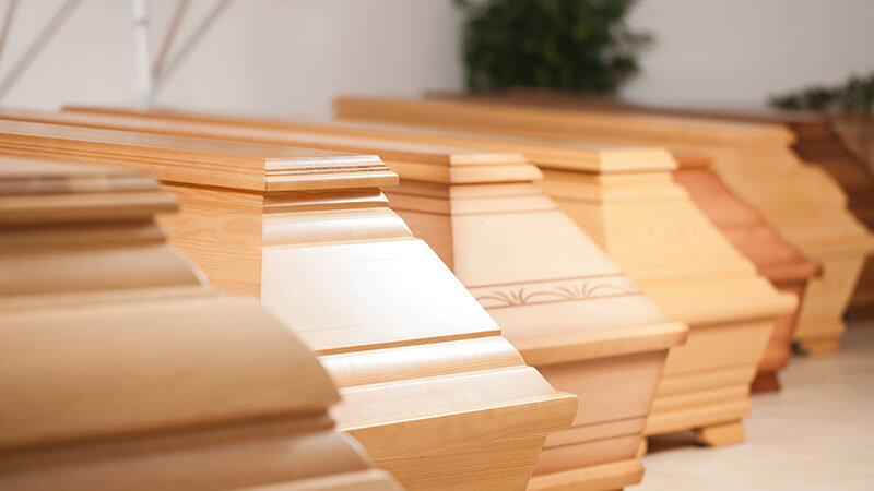 wooden funeral caskets sitting at crematory