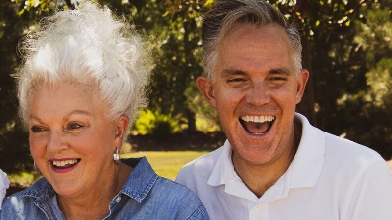 older man and woman laughing in park near Encino, CA