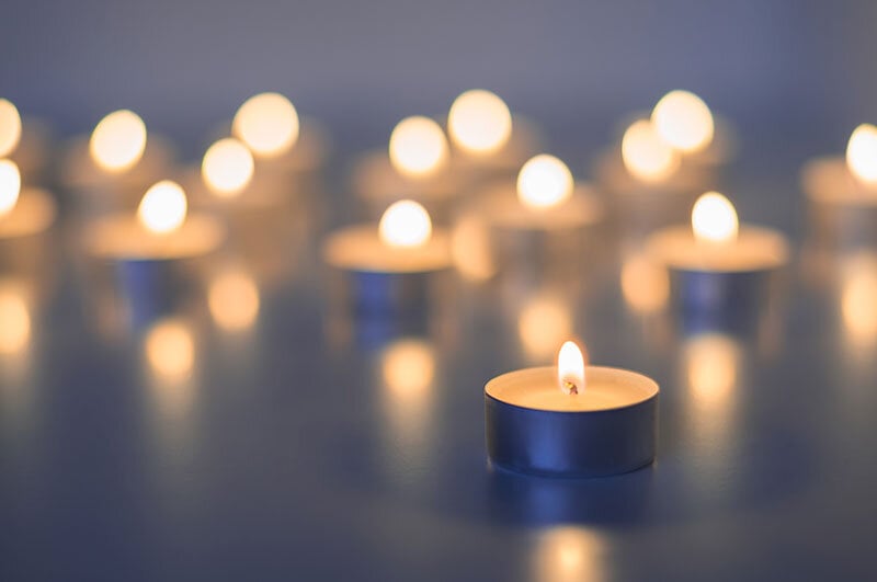 lit prayer candles at a funeral service