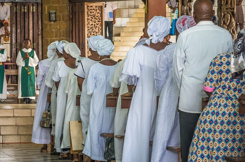 traditionally-dressed, african american women standing in a church
