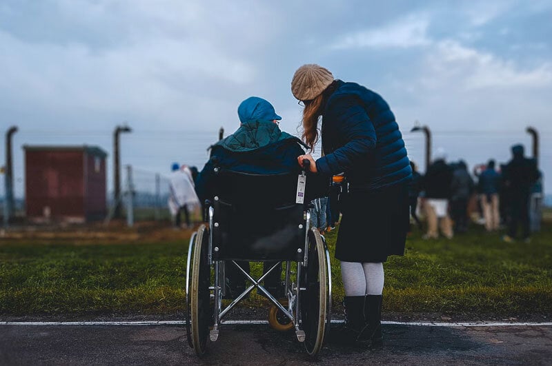 woman spending time with elderly person in wheelchair