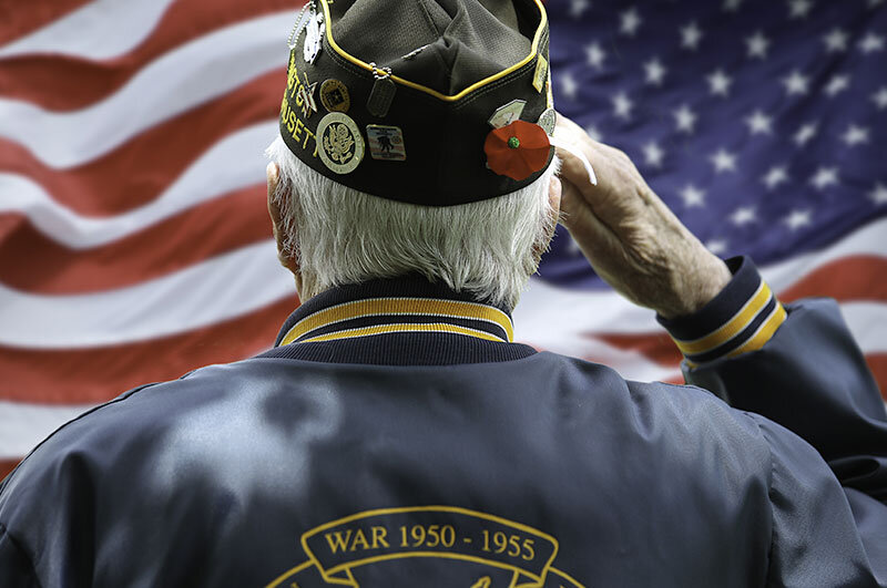 WWII Veteran saluting a flag at Naval Base Point Loma