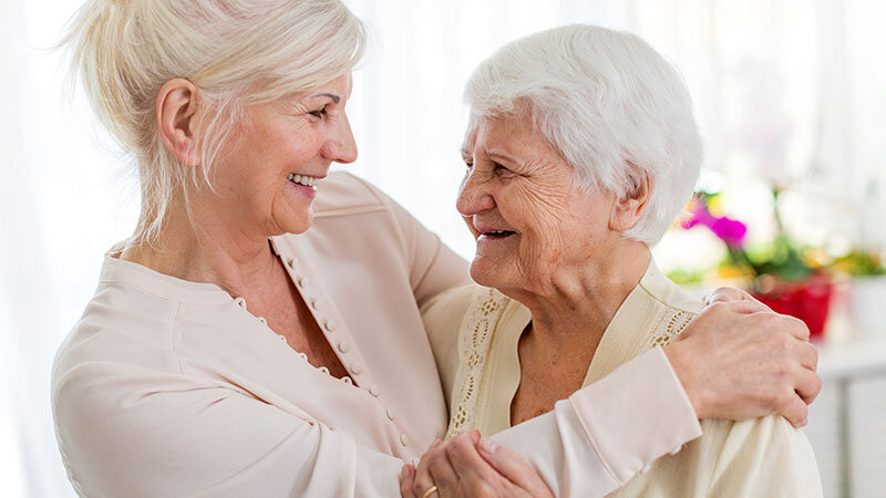 a death doula embracing an elderly patient at their home near Malibu, CA