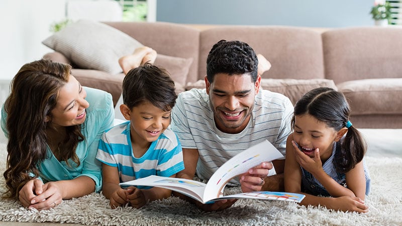 parents reading books about coping with death and grief to their young kids