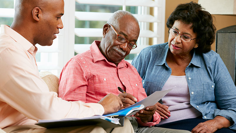 older couple signing Will at local los angeles office with attorney