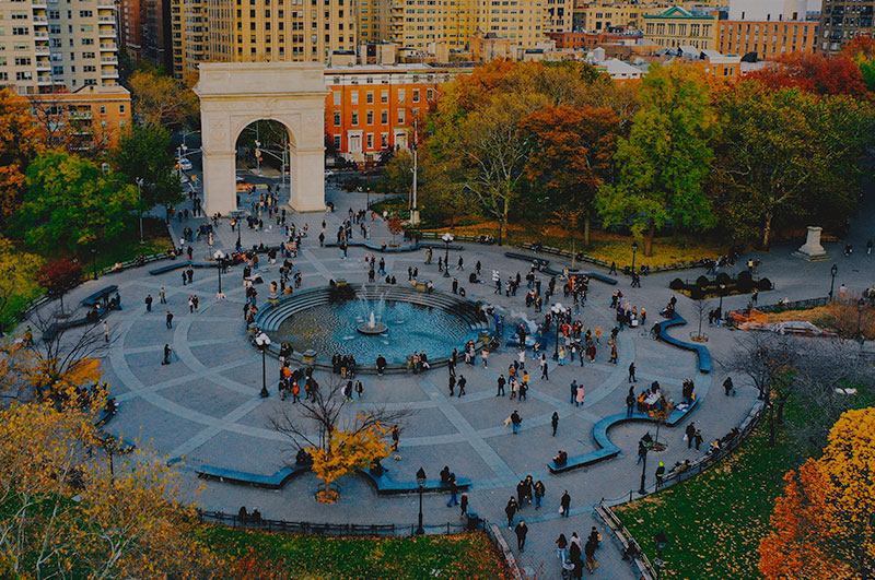 Washington Square Park in NYC with large gathering of people