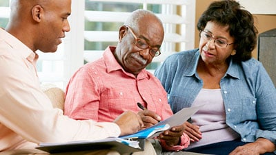 older couple reviewing end of life documents with attorney