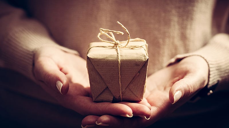 a sympathy gift, wrapped, and being presented