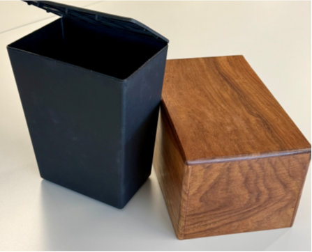A standard temporary urn and Opal’s handmade rosewood urn for cremated remains