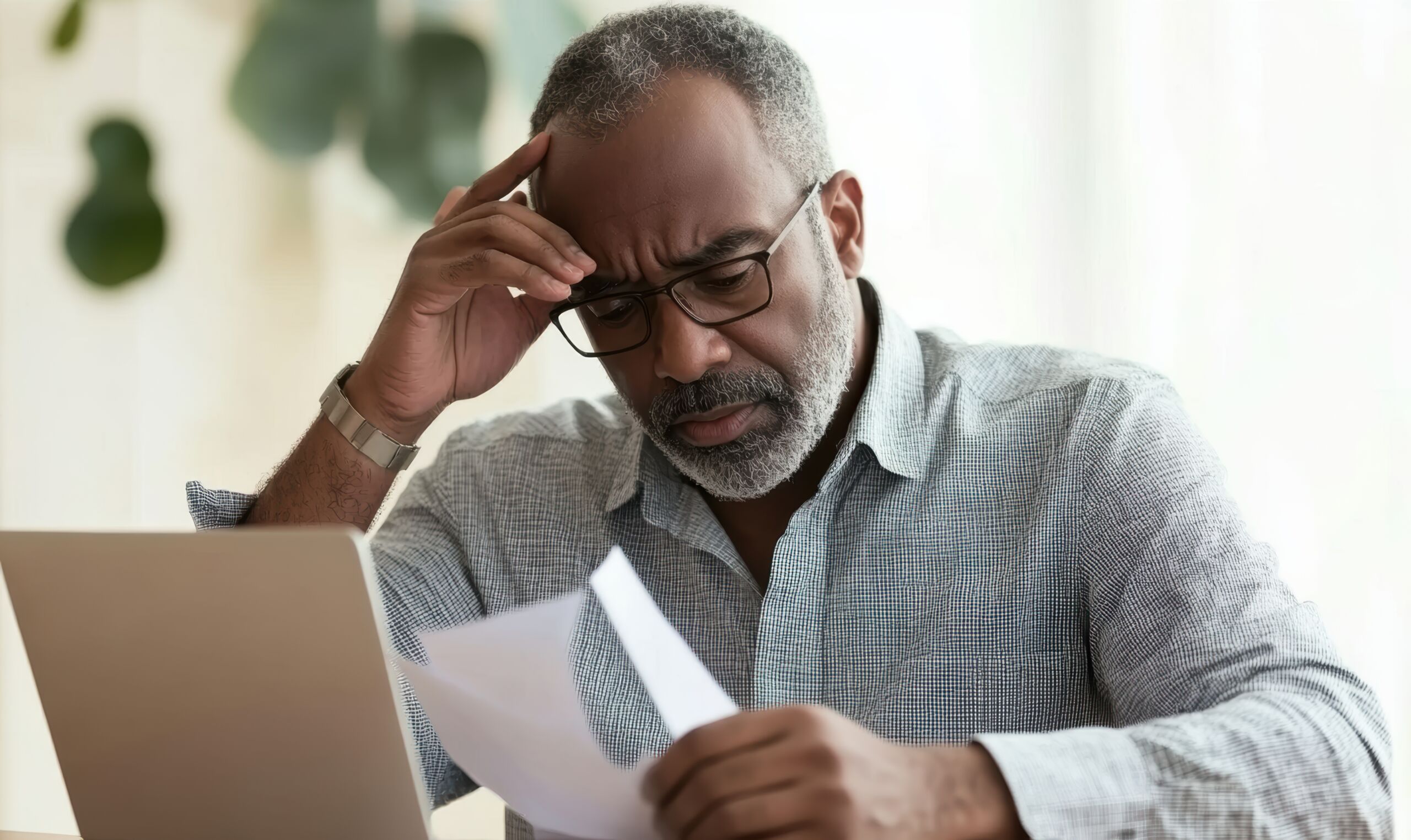 A man looks over various cremation contracts, trying to make the right choice for his family