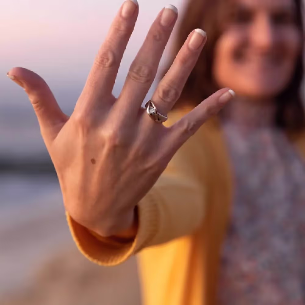 A woman shows off a diamond ring made with her loved one's ashes