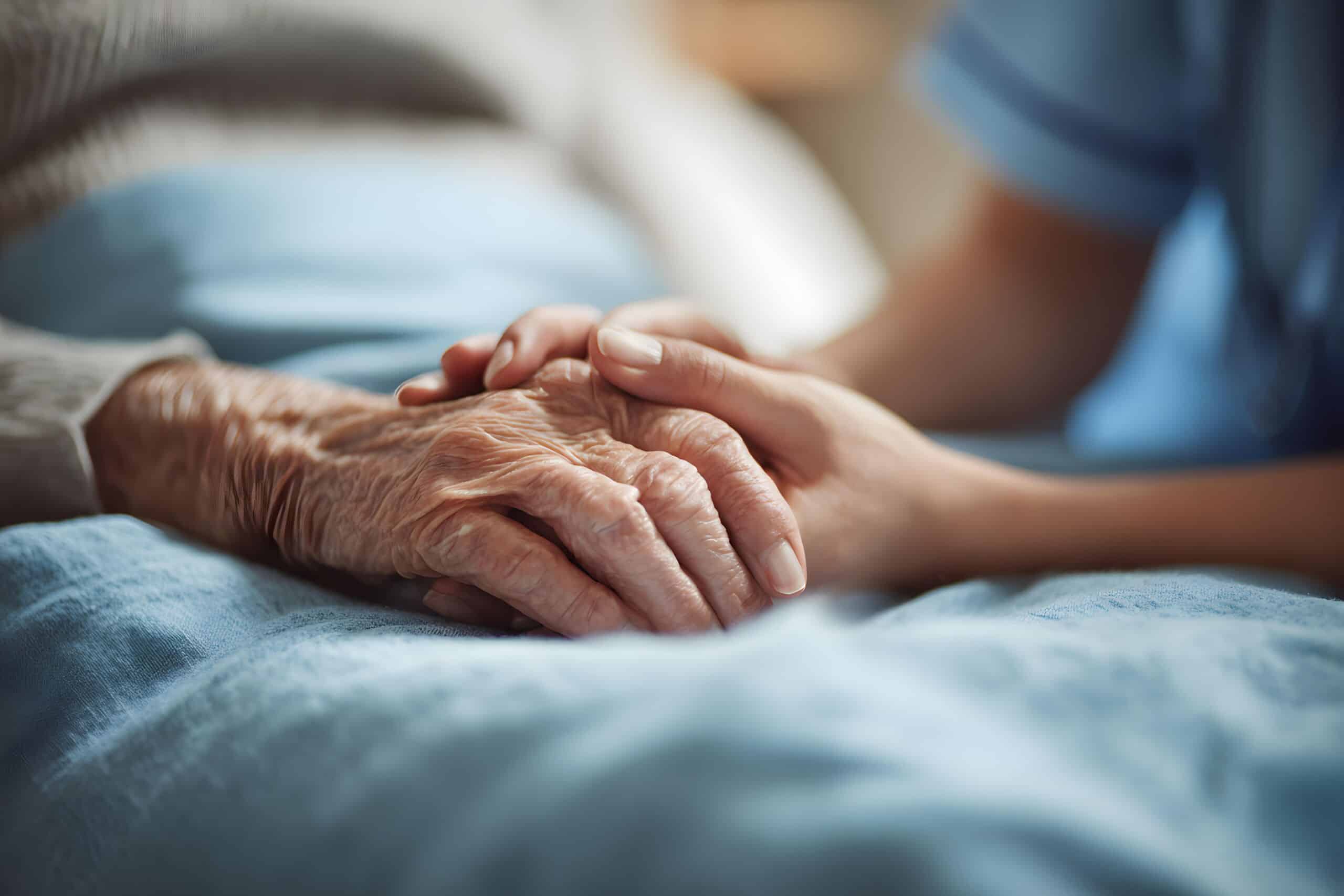Close up nurse holding the hands of elderly woman